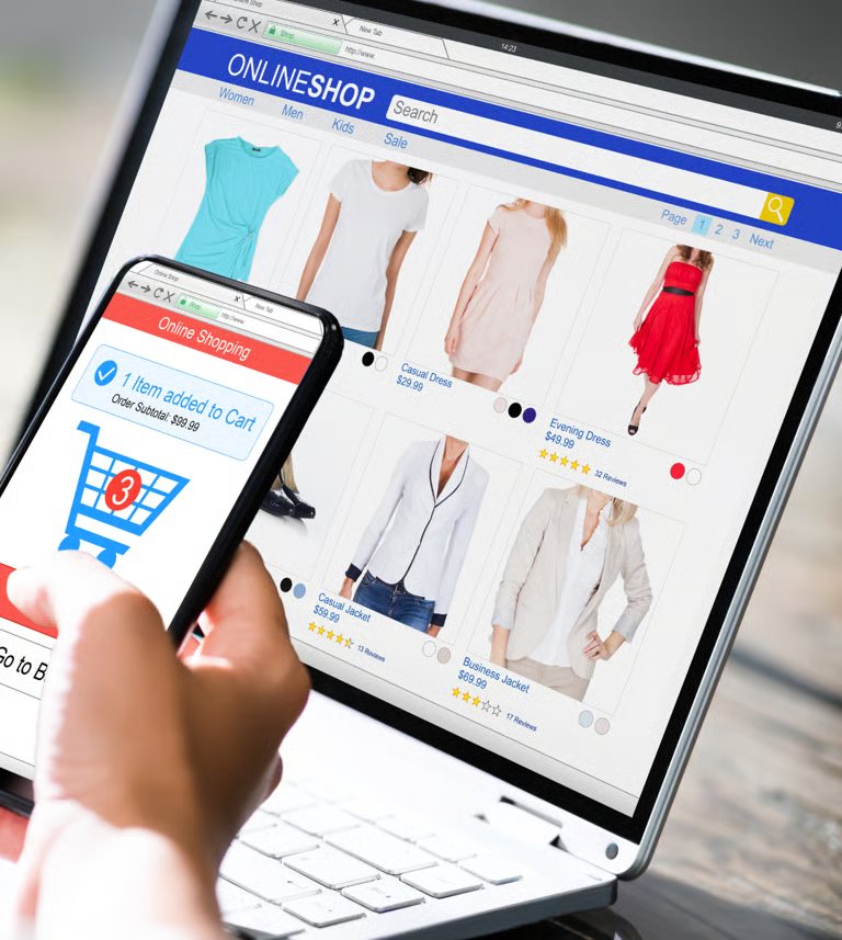 Online clothing store on laptop and smartphone